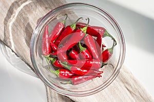 Chili pepper in a bowl on a white table