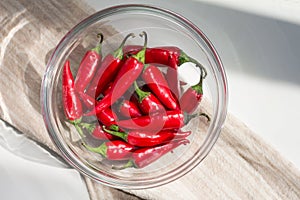 Chili pepper in a bowl on a white table