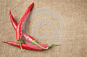 Chili pepper, paprika on sacking background