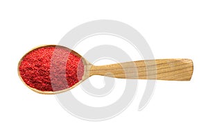 Chili pepper powder in wooden spoon isolated on white background. spice for cooking food, top view