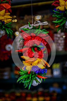 Chili pepper ristras, decorated with flowers and garlic, hanging at the Pike Place Market in Seattle