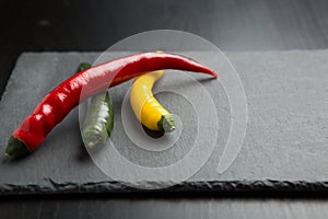Chili peppers on a slate stone slab