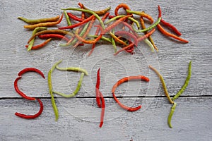 chili peppers on white wood background