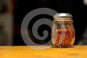 Chili powder bottle with bokeh background