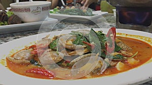 Chili sauce sambal clam Singaporean Malaysian seafood dish in hawker food centre