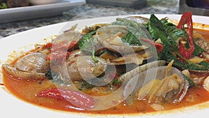 Chili sauce sambal clam Singaporean Malaysian seafood dish in hawker food centre