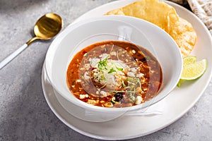 Chili served with crumbled cheese and tortilla