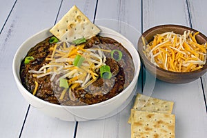 Chili top with cheese and green onions