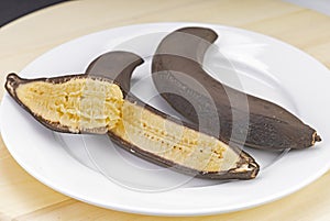 Chilled bananas, left at room temperature with mushy flesh on a white plate