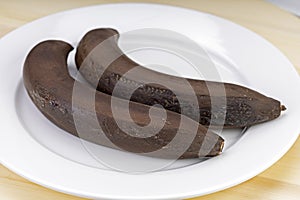 Chilled bananas, left at room temperature, on a white plate