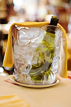 Chilled bottle of wine in a bucket with ice