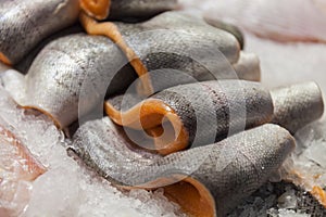 Chilled fillet of red fish. Pieces of fish lie on ice. Freezer shop counter. Sliceof fish lie on ice. Salmon. Close-up