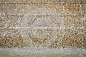 Chilled fountain water flowing down on the granite steps. Flowing of fountain water over a set of concrete stairs.