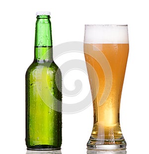 Chilled green bottle with condensate and a glass of beer