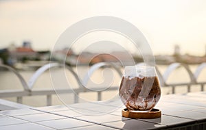 Chilled iced chocolate cocoa in glasses on the balcony by the river. Copy space