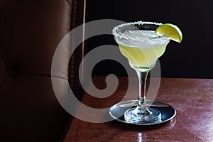 Chilled Margarita Cocktail with Salted Rim in Dark Bar