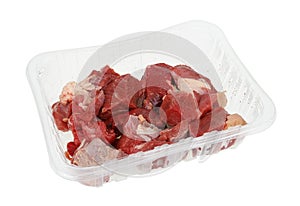 Chilled pieces of raw beef in a plastic container isolated