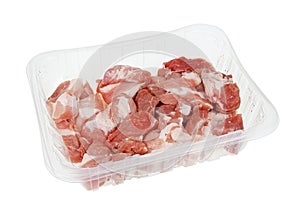 Chilled pieces of raw pork in a plastic container isolated