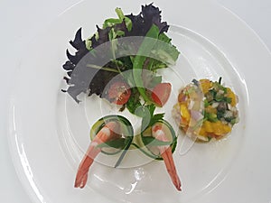 Chilled Prawn Cocktail with Mango Salsa and Mesclun Mix on white plate