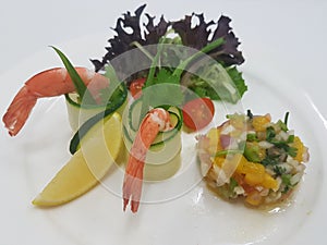 Chilled Prawn Coctktail with Mango Salsa and Mesclun Mix on white plate