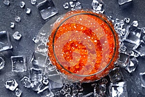 Chilled red caviar in a glass jar.