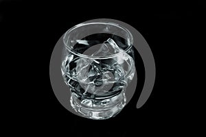 Chilled Water with Ice Cubes on Black Background