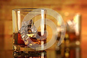 Chilled Whiskey Glass with Ice Cubes with bokeh