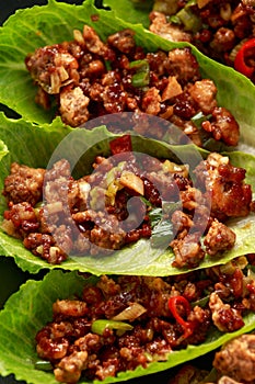 Chilli Beef Lettuce Wraps with sauce on black plate