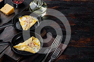 Chilli crab silky omlette , on frying iron pan, on dark wooden background  , with copyspace  and space for text