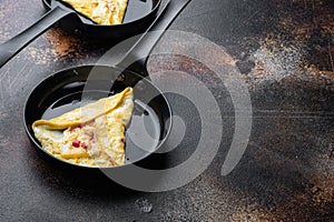 Chilli crab silky omlette , on frying iron pan, on old dark rustic background  , with copyspace  and space for text