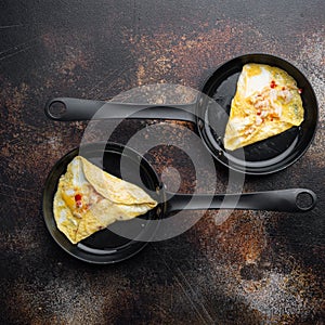 Chilli crab silky omlette , on frying iron pan, on old dark rustic background, top view flat lay