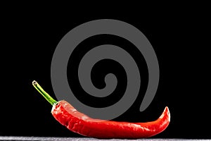 Chilli pepper isolated. Red hot chili paprika or spicy chile cayenne pepper isolated on black background. Ingredient for