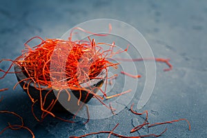 Chilli threads in small bowl on dark background