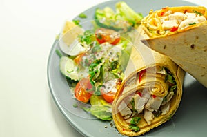 Chilli tortilla wrap with chicken breast, peppers, cucumber and mix salad