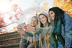 Chilling with my favourite people. a group of young friends posing for a selfie together outside.