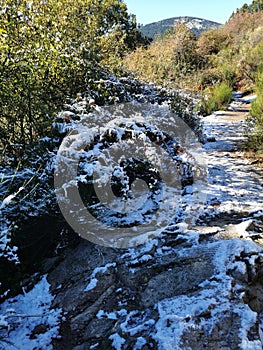 Chilling view of snow-covered rocks in Cercedilla, Sierra de Guadarrama in Spain photo