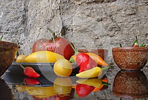 Chillis and heirloom tomatoes in rustic bowls