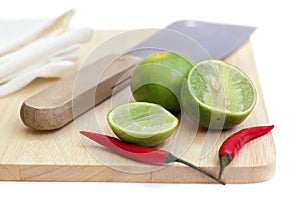 Chillis and lime on chopping board photo
