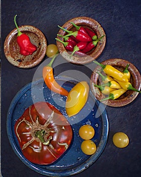 Chillis, Tomatoes, heirlooms in rustic ceramic bowls