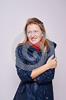 Chills. Warm clothes. Young girl. White background photo