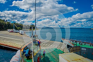 CHILOE, CHILE - SEPTEMBER, 27, 2018: Above view of cars inside of ferry and passengers for crossing from the Chilean