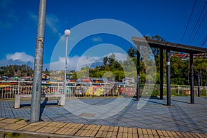 CHILOE, CHILE - SEPTEMBER, 27, 2018: Outdoor view of pier with some colorful palafitos in the horizont in Castro, Chiloe