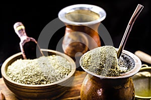 ChimarrÃ£o with yerba mate, a traditional drink from Brazil and South America, served on a wooden head and served with a metal