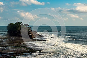 Chimeric temple on the water. Water temple in Bali. Indonesia nature landscape. Famous Bali landmark. Splashing waves photo