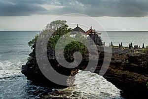 Chimeric temple on the water. Water temple in Bali. Indonesia nature landscape. Famous Bali landmark. Splashing waves photo