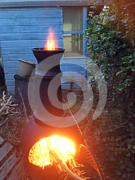 Chiminea fire burning in a backyard