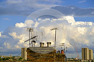 Chimney and antennae under beautiful sky photo