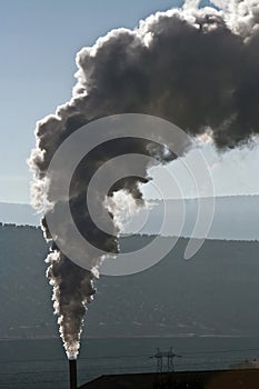 Chimney expelling pollutant gases to the air