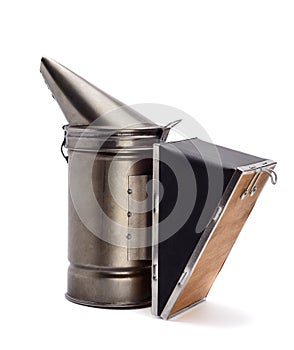 Chimney for flashing bees. The beekeeper`s tool. Bee smoker smoking.