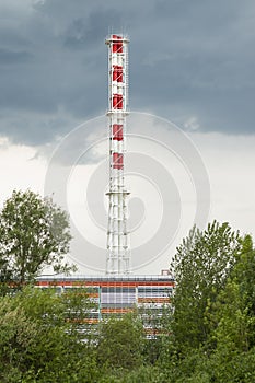 The chimney of a gas boiler house for heating residential buildings in the city. The chimney is an atmospheric pollutant.